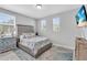 Bedroom featuring a queen bed, two windows, a dresser, and a mounted television at 2283 Arlington St, Sarasota, FL 34239
