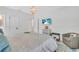 Bright bedroom featuring a queen bed, a mounted television, an accent chair, and a chandelier at 2283 Arlington St, Sarasota, FL 34239