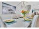 Dining room with modern chandelier, seating for six, and decorative ocean-themed wall art at 2283 Arlington St, Sarasota, FL 34239