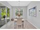 Bright dining area with modern chandelier and sliding glass doors to an outdoor patio space at 2283 Arlington St, Sarasota, FL 34239