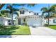 Charming two-story home featuring a well-manicured lawn, a two-car garage, and decorative palm trees at 2283 Arlington St, Sarasota, FL 34239