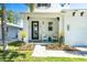 Inviting front porch with seating and lovely landscaping creates curb appeal at 2283 Arlington St, Sarasota, FL 34239