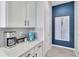 Charming kitchen area featuring modern coffee appliances, sleek countertops, and a pop of color on the accent wall at 2283 Arlington St, Sarasota, FL 34239
