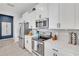 Modern kitchen with stainless steel appliances, white cabinetry, and stylish backsplash, creating a sleek cooking space at 2283 Arlington St, Sarasota, FL 34239