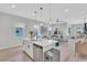 Contemporary kitchen boasts white cabinetry, stainless appliances, and seamless flow to an inviting living space at 2283 Arlington St, Sarasota, FL 34239