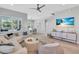 Bright living room featuring a comfortable white sofa, modern decor, and a view of the dining area at 2283 Arlington St, Sarasota, FL 34239
