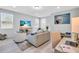 Bright living room features a beach themed television and neutral decor at 2283 Arlington St, Sarasota, FL 34239