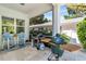 Back patio area with a grill, a Big Green Egg, and blue outdoor furniture at 2283 Arlington St, Sarasota, FL 34239