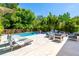 Outdoor living space with a pool, lounge seating, and lush landscaping at 2283 Arlington St, Sarasota, FL 34239