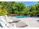 Relaxing pool and lounge area surrounded by lush tropical landscaping for privacy at 2283 Arlington St, Sarasota, FL 34239