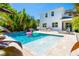 Backyard pool and deck with mature landscaping, lounge chairs, and an outdoor kitchen at 2283 Arlington St, Sarasota, FL 34239