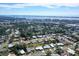 Expansive aerial view showcases the neighborhood, highlighting proximity to water and urban amenities in the distance at 2434 Carlisle Pl, Sarasota, FL 34231