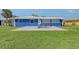 A beautiful blue house with a concrete patio and green lawn at 2434 Carlisle Pl, Sarasota, FL 34231