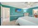 Bedroom boasts teal-blue walls, white trim, and doorway views to the hallway and bathroom at 2434 Carlisle Pl, Sarasota, FL 34231