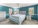 Bedroom features blue walls, white trim, and a bed with matching nightstands and dressers at 2434 Carlisle Pl, Sarasota, FL 34231