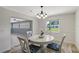 Charming dining room with a round table, elegant chandelier, and view of the backyard at 2434 Carlisle Pl, Sarasota, FL 34231