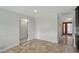 Neutral dining room featuring tile floor, wainscoting and passage to bathroom and door with decorative glass at 2434 Carlisle Pl, Sarasota, FL 34231