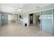 Spacious Florida room showcasing wood-look floors, and access to dining area, kitchen, and the living room at 2434 Carlisle Pl, Sarasota, FL 34231