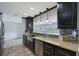 Modern kitchen features granite countertops, stainless steel appliances, and dark wood cabinets at 2434 Carlisle Pl, Sarasota, FL 34231