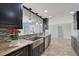 This kitchen features granite countertops, stainless steel appliances, and dark wooden cabinets at 2434 Carlisle Pl, Sarasota, FL 34231