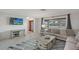 Cozy living room features modern decor, a comfortable sofa, and a mounted flat-screen TV for relaxed living at 2434 Carlisle Pl, Sarasota, FL 34231