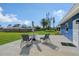 Open-air patio featuring a table with chairs overlooking the landscaped backyard at 2434 Carlisle Pl, Sarasota, FL 34231