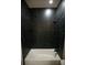 Modern bathroom with a black marble tiled shower/bathtub with black fixtures at 2760 Adele St, North Port, FL 34291