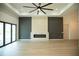 Modern living room with a sleek fireplace, accent wall, and expansive sliding glass doors for indoor-outdoor living at 2760 Adele St, North Port, FL 34291