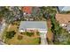 An aerial view showcases this home, complete with an outdoor living space, lush landscaping, and a well-maintained roof at 317 Harbor S Dr, Venice, FL 34285