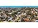 Attractive aerial view of a neighborhood with landscaped homes, mature trees, and the ocean horizon in the distance at 317 Harbor S Dr, Venice, FL 34285