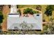 This aerial view captures the house's well-kept roof, concrete driveway, landscaped yard, and brick patio at 317 Harbor S Dr, Venice, FL 34285