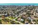 Wide aerial shot of a residential community with tree-lined streets and a view of the ocean skyline at 317 Harbor S Dr, Venice, FL 34285