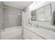 Bathroom featuring a sleek bathtub and vanity with grey granite countertop at 317 Harbor S Dr, Venice, FL 34285