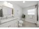 Bathroom featuring a vanity with light granite countertop and framed mirror at 317 Harbor S Dr, Venice, FL 34285