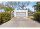 Detached two-car garage with white exterior and decorative window cutouts at 317 Harbor S Dr, Venice, FL 34285
