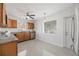 Functional kitchen featuring wood cabinets, stainless steel appliances, and a well-lit space for meal preparation at 317 Harbor S Dr, Venice, FL 34285