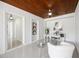 Bright living room with polished tile floor, wood plank ceiling and view of the adjacent room at 317 Harbor S Dr, Venice, FL 34285