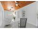 Well-lit living room with light-colored tile floors and warm wood ceiling with ceiling fan at 317 Harbor S Dr, Venice, FL 34285