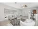 Inviting living area with bright light, tile flooring, and an open floor plan to dining and kitchen spaces at 317 Harbor S Dr, Venice, FL 34285