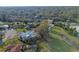 Birds-eye view of property featuring lush green landscape, mature trees, and beautiful neighborhood at 3215 Pine Valley Dr, Sarasota, FL 34239