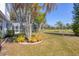 Expansive backyard featuring lush landscaping and a screened-in pool area, perfect for outdoor enjoyment at 3215 Pine Valley Dr, Sarasota, FL 34239