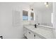 Bright bathroom featuring a sink with modern faucet, ample counter space, and a large mirror at 3215 Pine Valley Dr, Sarasota, FL 34239
