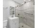 Modern bathroom featuring a glass-enclosed shower, white vanity, and updated fixtures at 3215 Pine Valley Dr, Sarasota, FL 34239