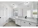 Bathroom features a vanity area, large mirror, and abundant natural light from a window at 3215 Pine Valley Dr, Sarasota, FL 34239