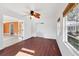 Bedroom with hardwood floors, a ceiling fan, and large windows at 3215 Pine Valley Dr, Sarasota, FL 34239