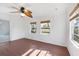 Bright bedroom with hardwood floors, a ceiling fan, and windows providing ample natural light at 3215 Pine Valley Dr, Sarasota, FL 34239