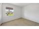 Bright bedroom with a large window offering a pleasant outdoor view and natural light at 3215 Pine Valley Dr, Sarasota, FL 34239
