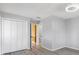 Neat bedroom with gray walls, wood floors, and a spacious closet for storage at 3215 Pine Valley Dr, Sarasota, FL 34239