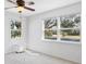 A bright bedroom features lots of light from its oversized windows and neutral carpet at 3215 Pine Valley Dr, Sarasota, FL 34239