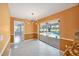 Dining room with view of the pool, decorative chandelier, and tile flooring at 3215 Pine Valley Dr, Sarasota, FL 34239